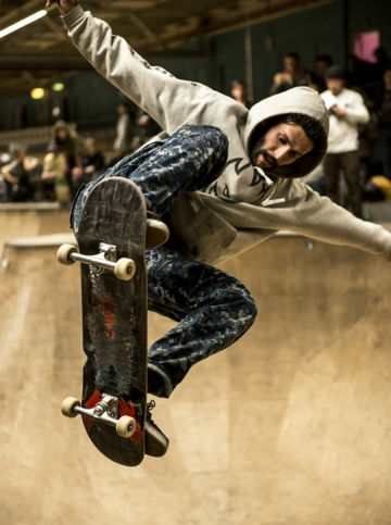 man riding skateboard and doing ollie trick